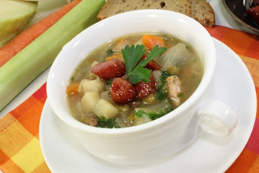 a cup of cabbage soup and fresh parsley