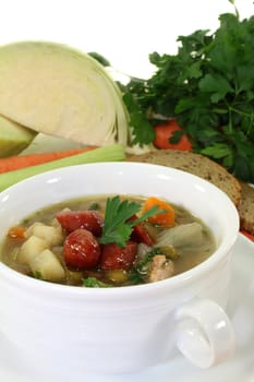 a cup of cabbage soup and fresh parsley