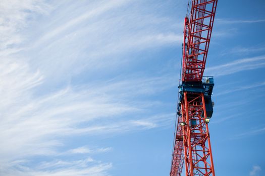 Low angle view of a construction crane with blue sky in the background.