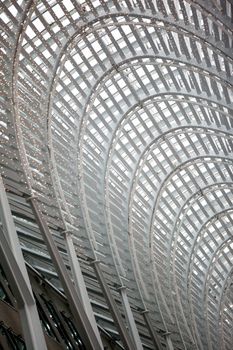 Low angle cropped shot of a arched structure with steel frames.