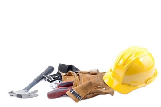 Hardhat, hammer, tool belt and screw driver on a white background