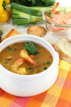 fresh healthy bouillabaisse with seafood and parsley on a light background