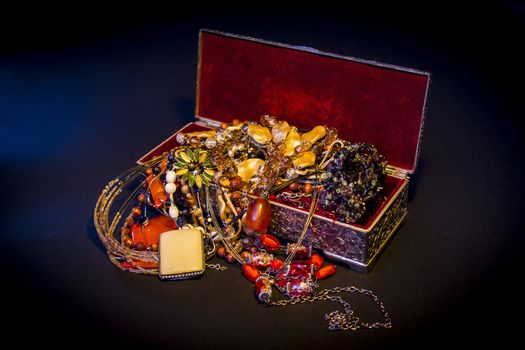 Silver treasure box in the dark, full of necklaces and jewelery