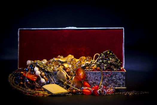 Silver treasure box in the dark, full of necklaces and jewelery