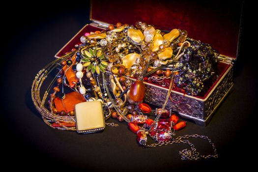 Silver treasure box in the dark, full of necklaces and jewelery