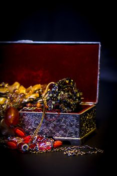 Silver treasure box in the dark, full of necklaces and jewelery