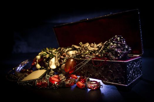 Silver treasure box in the dark, full of necklaces and jewelery