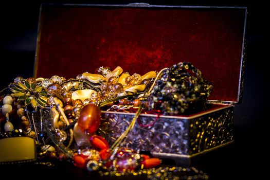 Silver treasure box in the dark, full of necklaces and jewelery