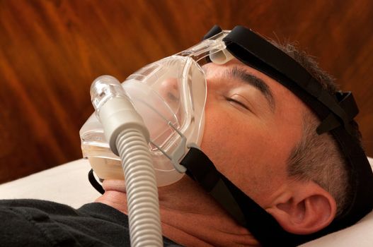 Man with sleeping apnea and CPAP machine