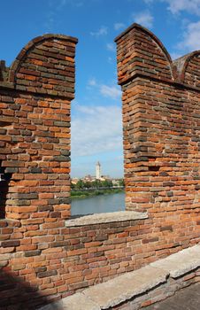 View from famous Castelvecchio Bridge in Verona toward Basilica di San Zeno over the river.