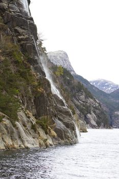 steep rock at coast in norway - vertical image