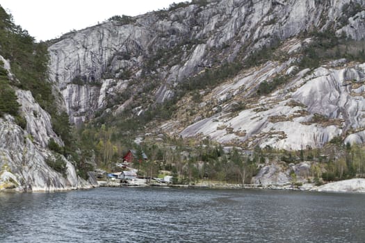 landscape in norway with buildings at steep coast