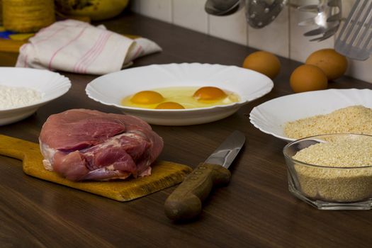 preparations for cooking schnitzel in the kitchen