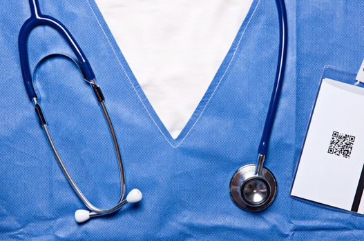 Closeup photo of a doctor chest, wearing a stethoscope around the neck and an ID card