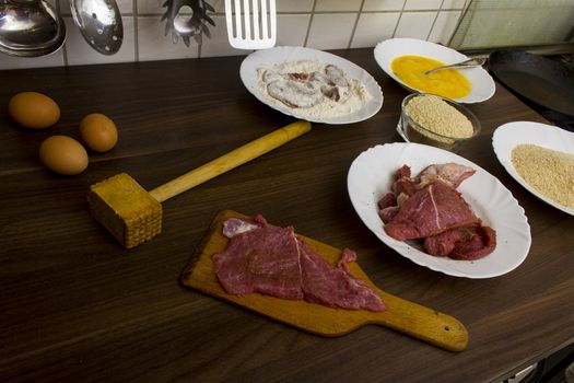 preparations for cooking schnitzel in the kitchen