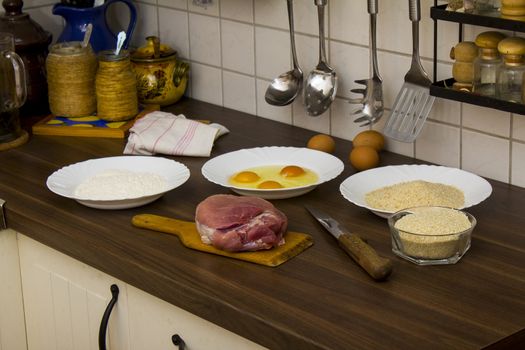 preparations for cooking schnitzel in the kitchen