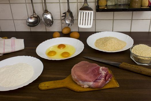 preparations for cooking schnitzel in the kitchen