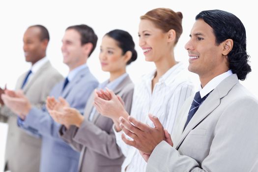 Close-up of  happy business people applauding against white background