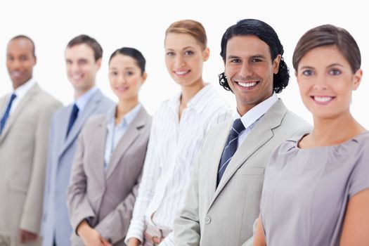 Close-up of smiling business people with focus on the second man against white background