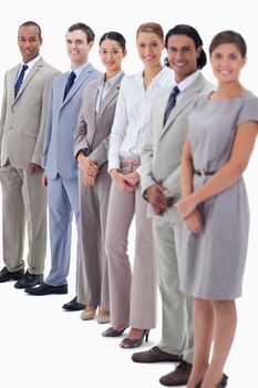 Happy business people looking straight with focus on the last two people against white background