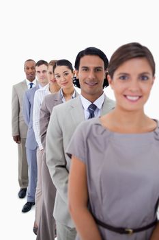 Close-up of co-workers in a single line looking straight with focus on the second woman against white background