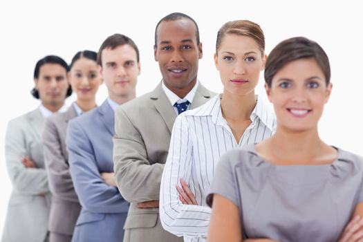 Big close-up of a business team in a single line crossing their arms with focus on the first man