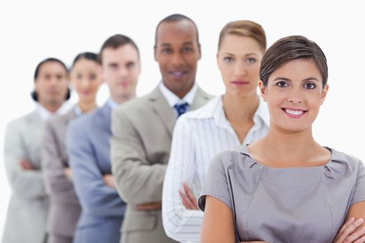 Close-up of a business team in a single line crossing their arms with focus on the first woman
