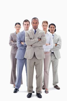 Determined business team crossing their arms against white background