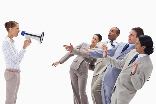 Woman yelling at co-workers through a megaphone against white background
