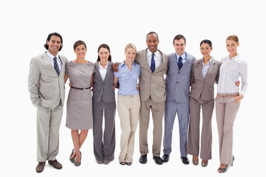Business team arm in arm against white background