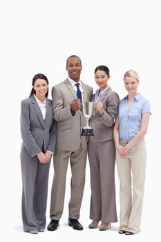 Business team holding a cup against white background