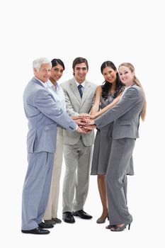 Happy people putting their hands on each others against white background