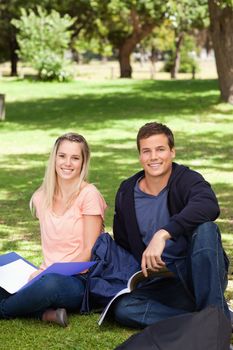Portrait of two students in a park studying