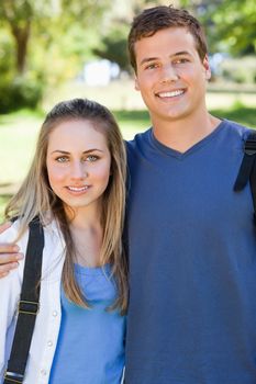 Portrait of a young couple smiling in a park