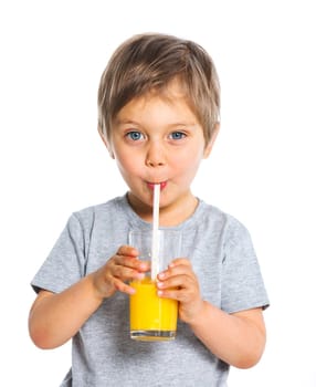 Portrait of happy little boy drinking orange juice. Isolated over white background.