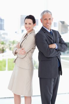 Business people looking at the camera and smiling while standing upright