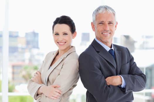 Businessman and his young secretary standing upright side by side
