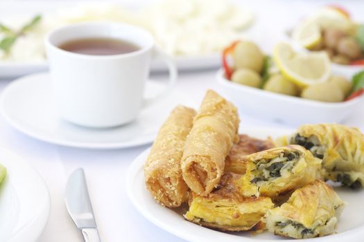 Breakfast with tea, olives and pastries