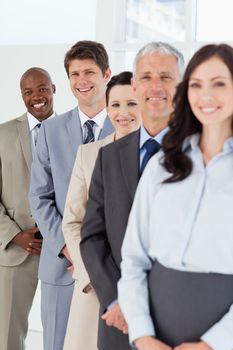 Smiling employees standing in the back while laughing and following their team