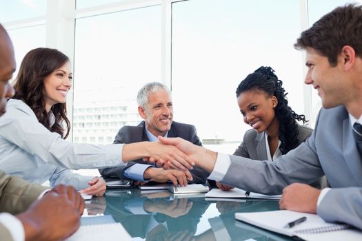 Handshake between a businesswoman and a co-worker when a meeting is ending