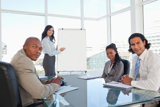 Serious business team almost smiling during a presentation in a meeting room