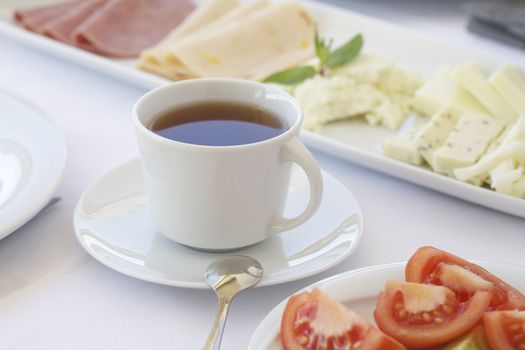 Breakfast table with cheese and tomatoes