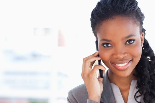 Smiling businesswoman looking ahead while talking on a phone