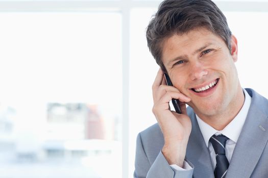 Laughing businessman talking on the phone