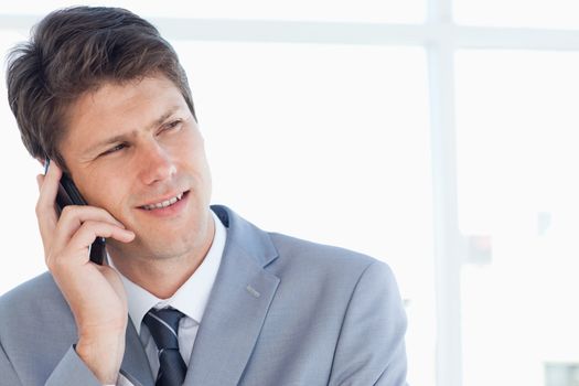 Confident businessman talking on the phone with a serious expression