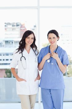 Young and smiling medical interns wearing their hospital uniform