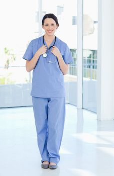 Young and confident medical intern wearing a blue short-sleeve uniform 