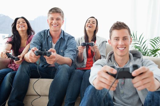 A group of friends enjoying a game together while looking into the camera