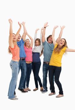 A group looking to the side as they jump in the air while cheering