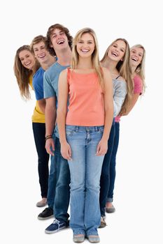 A full length shot of a group of people looking at the camera at various angles 